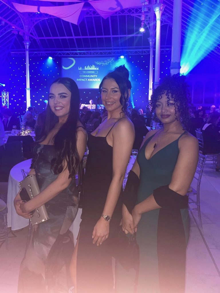 Three team members at the community impact awards 